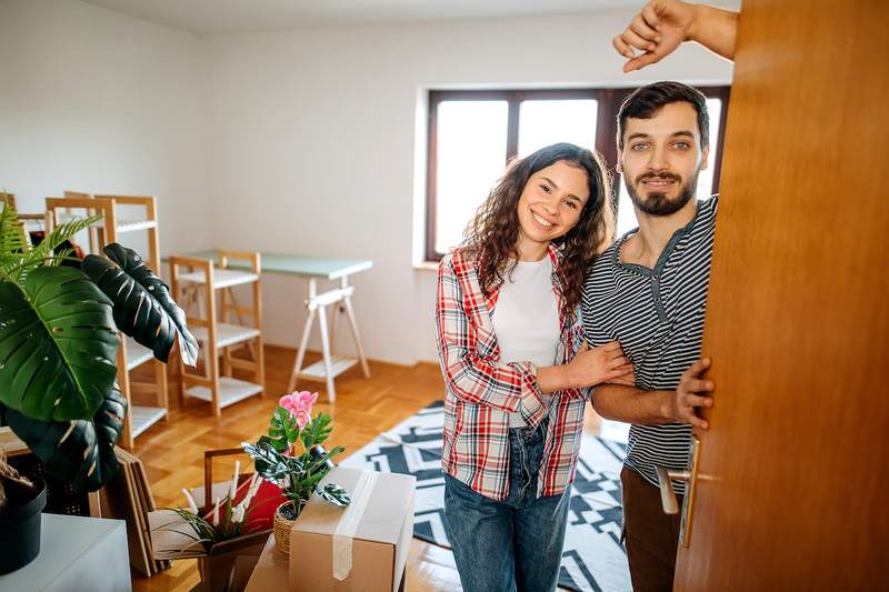 Couple welcomes you to their new home as they unpack.