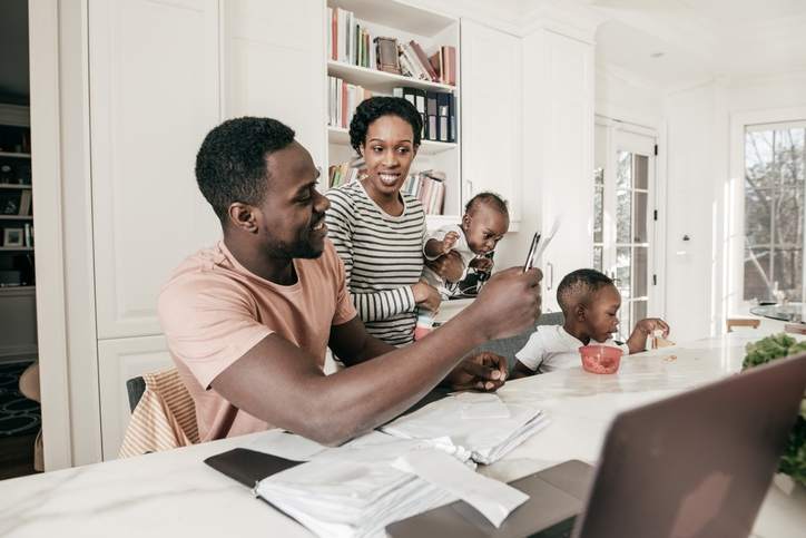 A family reviews finances in the kitchen.