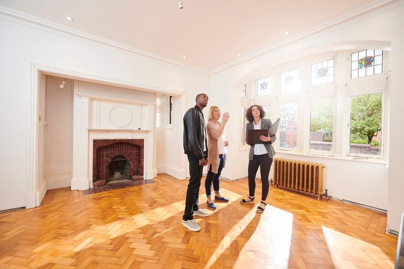 Surprised couple buying a house with a real estate agent.