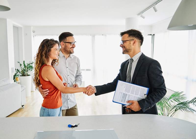 A seller and homebuyer shake hands after contingencies are met.