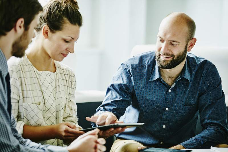 Couple reviews mortgage rates with financial advisor.