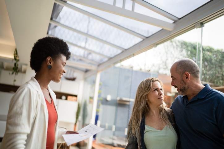 A couple discusses their refinancing options with a loan officer.