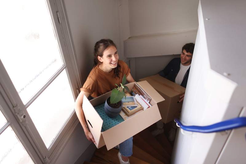 Couple moving into their new home with confidence because of owners title insurance.