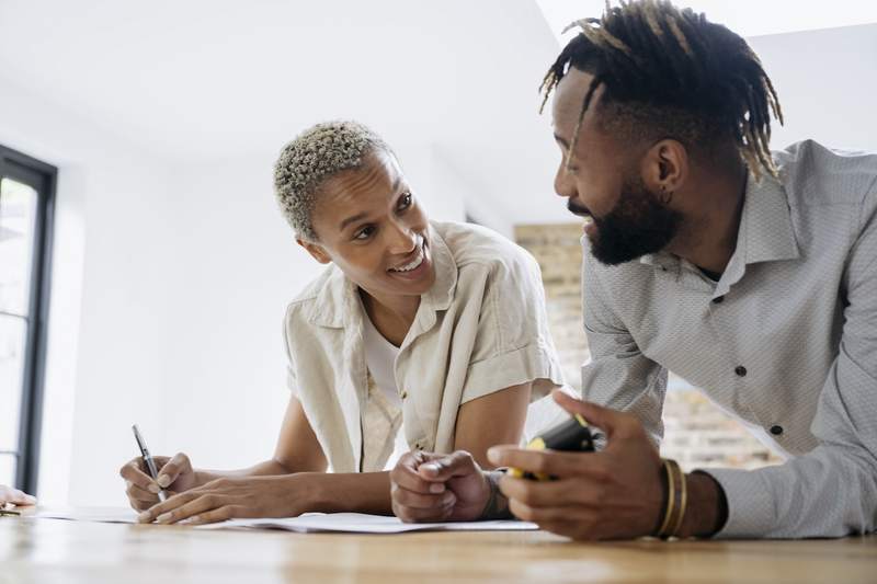 Couple works on paperwork for a cash-out refinance.