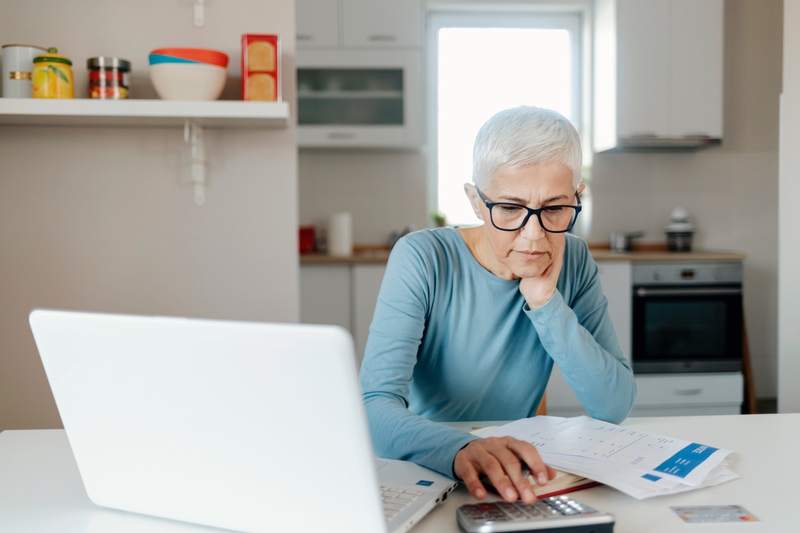 A woman calculates interest rates before buying a home.