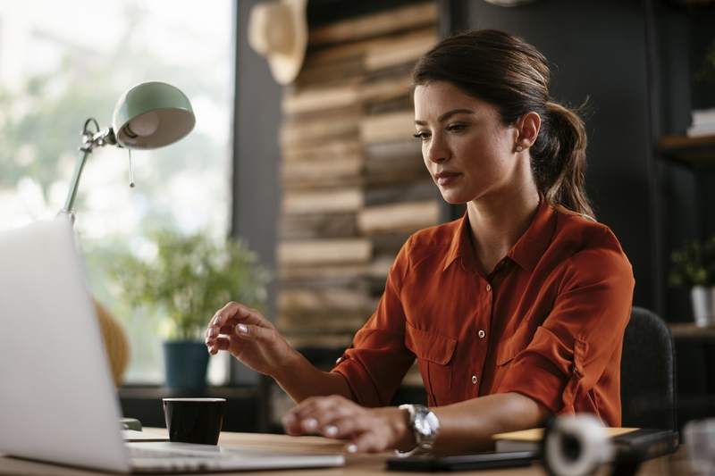 An office worker researches information on mortgage underwriting.