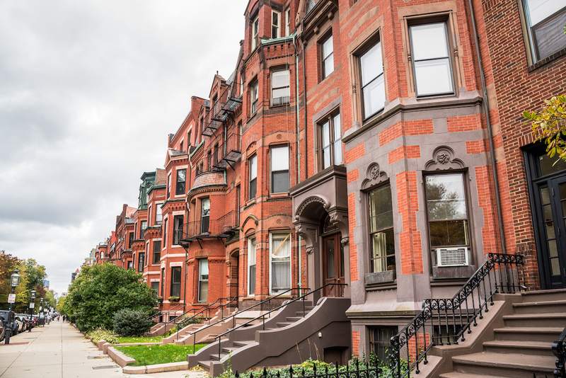 A view of a row of historic red-brick residential buildings.