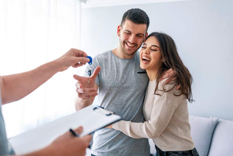 Couple takes the keys to their new home.