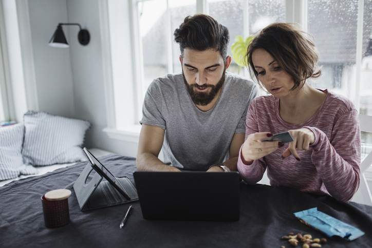 Couple with credit card looks at their refinancing options with poor credit.