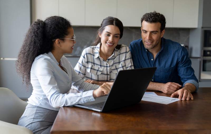 A couple conducts a title search with an agent.