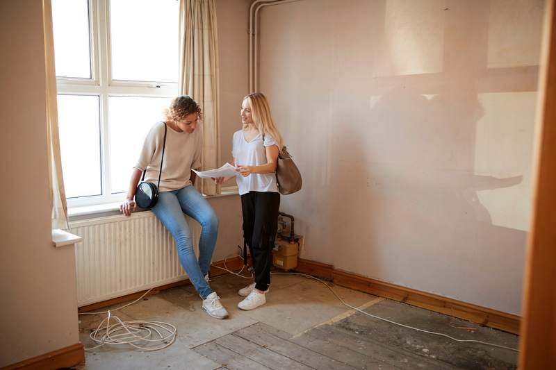 Two women look at a home for sale 'as is.'