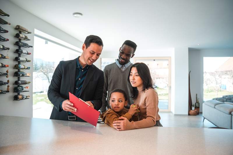 A family asks questions on a house tour.