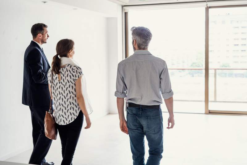 Couple and agent walk through home before closing.