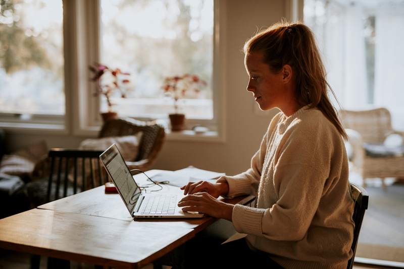 Homebuyer researches mortgages on a laptop.