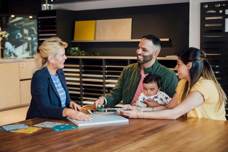 Diverse family pays for home renovations materials using funds from a second mortgage.