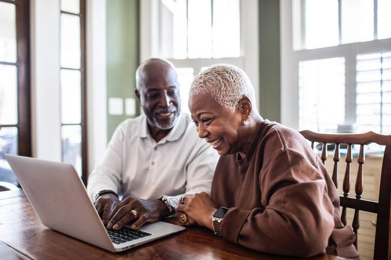 An older couple is excited as they use their 401(k) to buy a home.