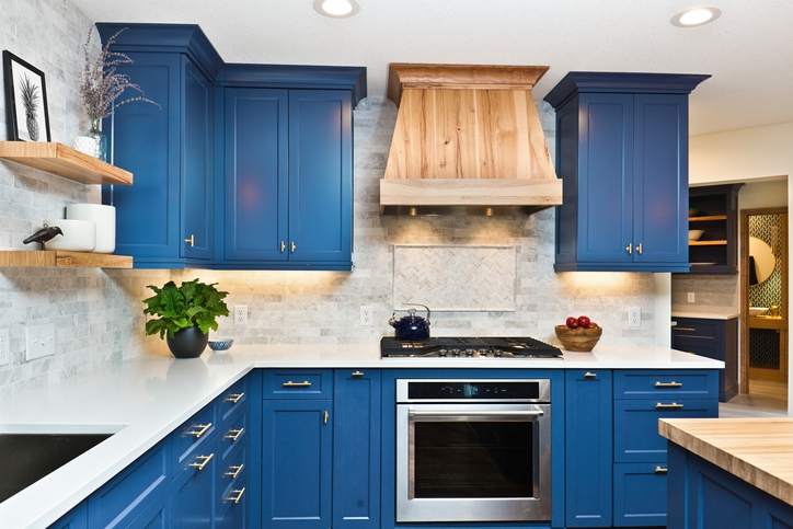 Kitchen with blue cabinets renovated after a cash-out refinance.