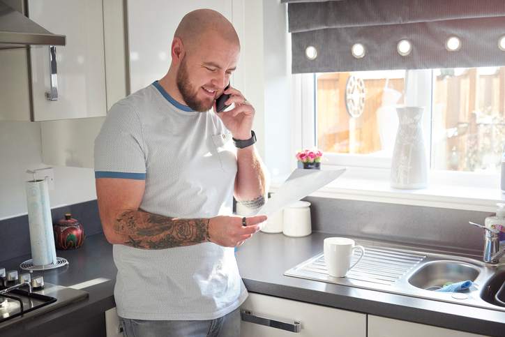 A homeowner talking to customer services sorting his home finances out.