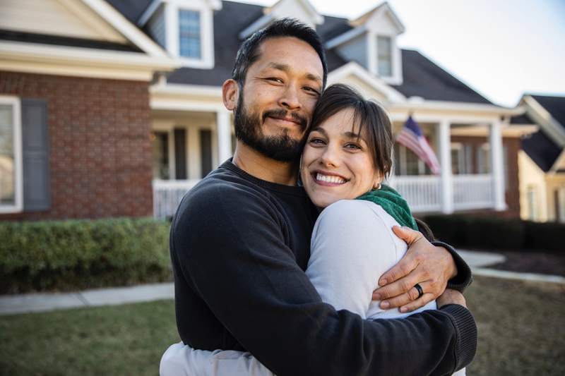 A couple celebrates after buying a home without a Realtor.