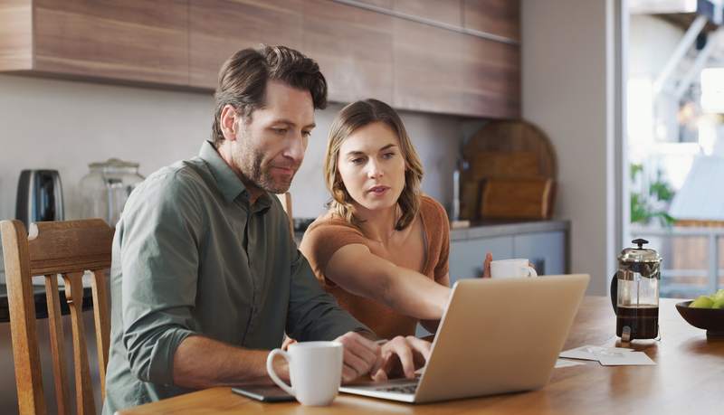 Couple researching online and considering an interest-only mortgage.