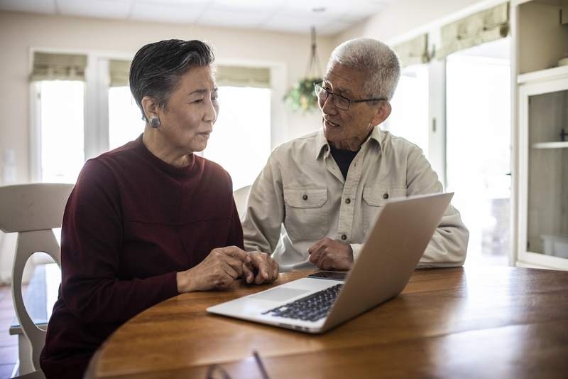 Older couple discusses reverse mortgage options for their home.